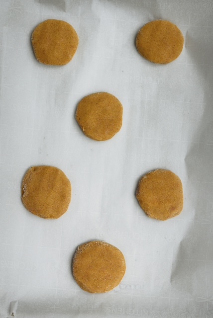 pumpkin cheesecake cookie dough balls on parchment paper of a baking sheet