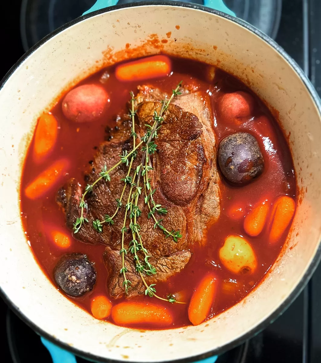 pot roast stew with vegetables in a dutch over