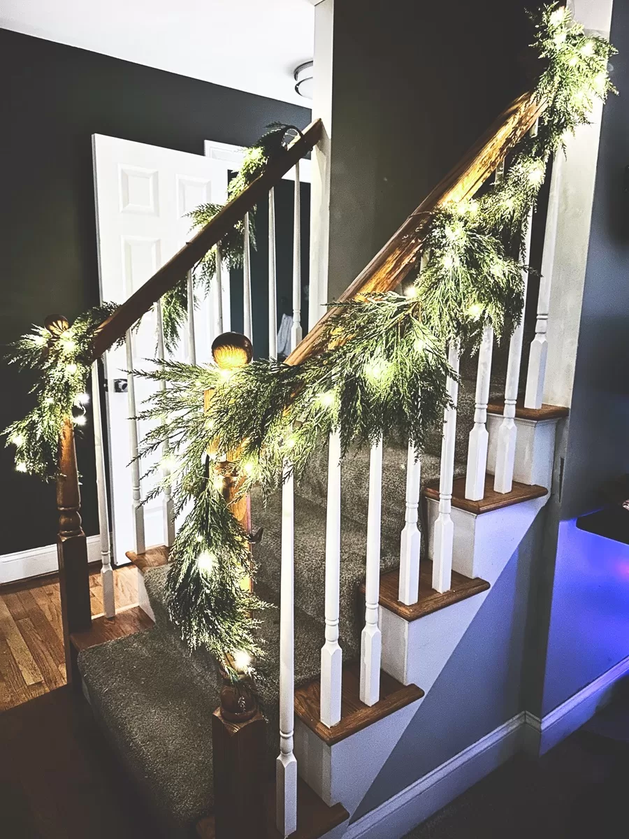 Twinkling lights on stairway Christmas garland