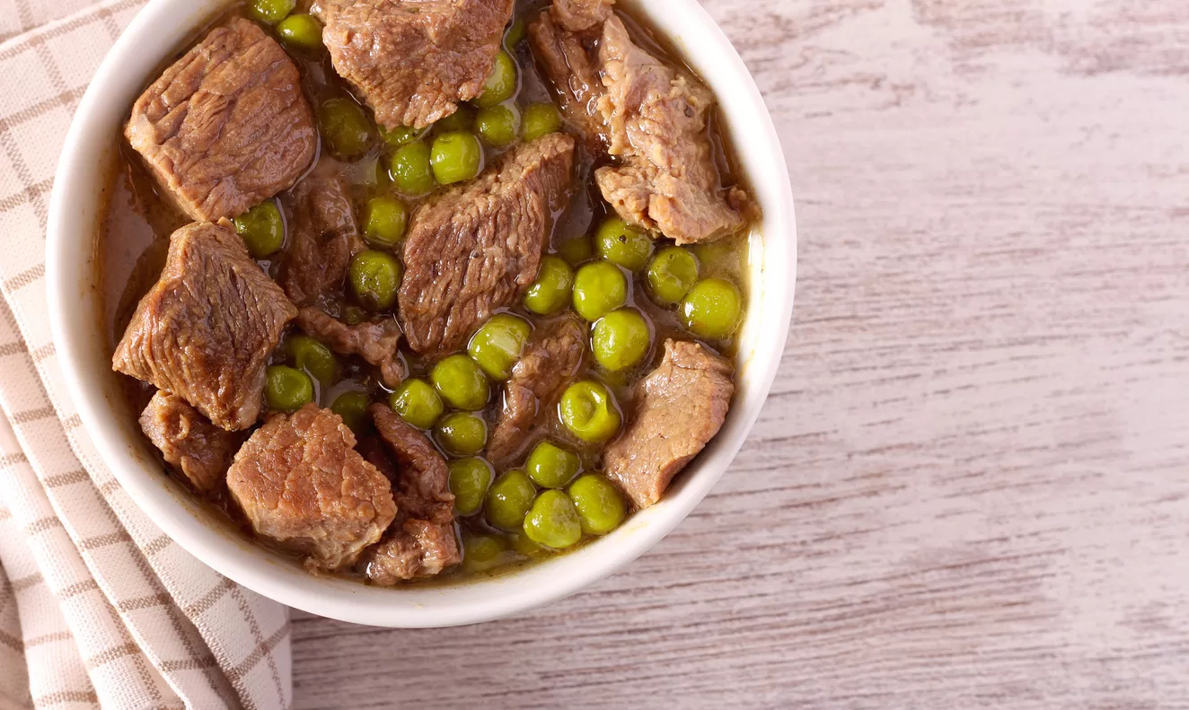 steak and peas in a bowl