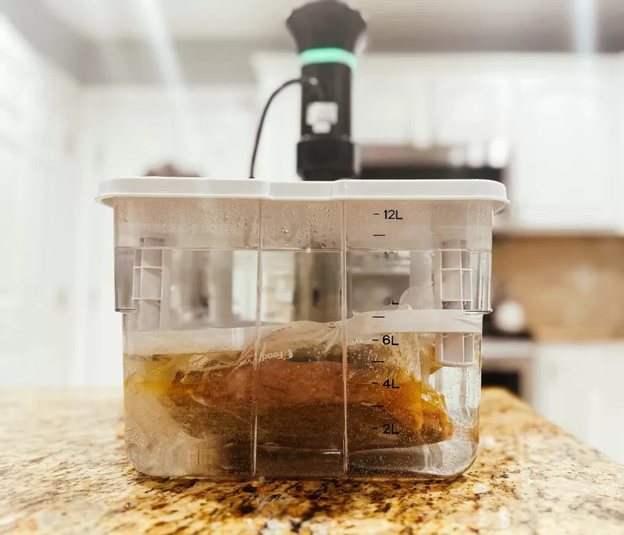 sous vide with 3 steaks submerged in bath