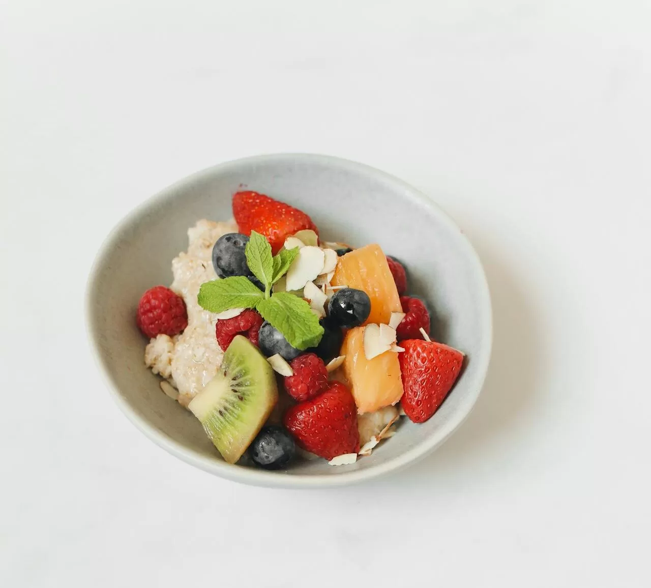 bowl of oatmeal topped with fruit