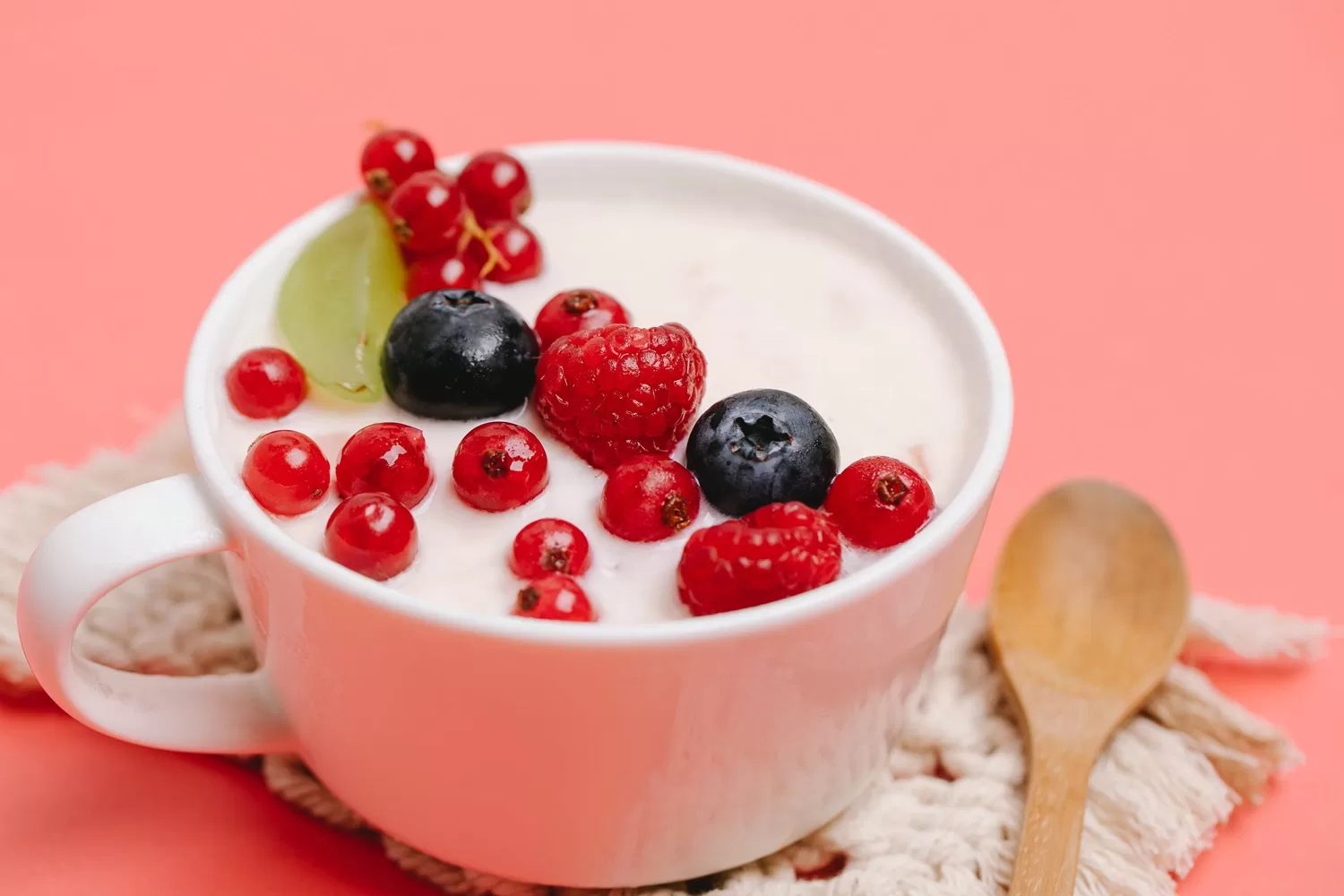 bowl of greek yogurt topped with raspberries and blueberries