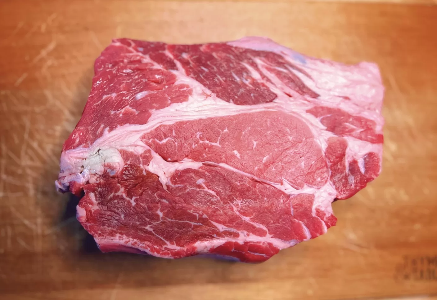 raw chuck roast on cutting board