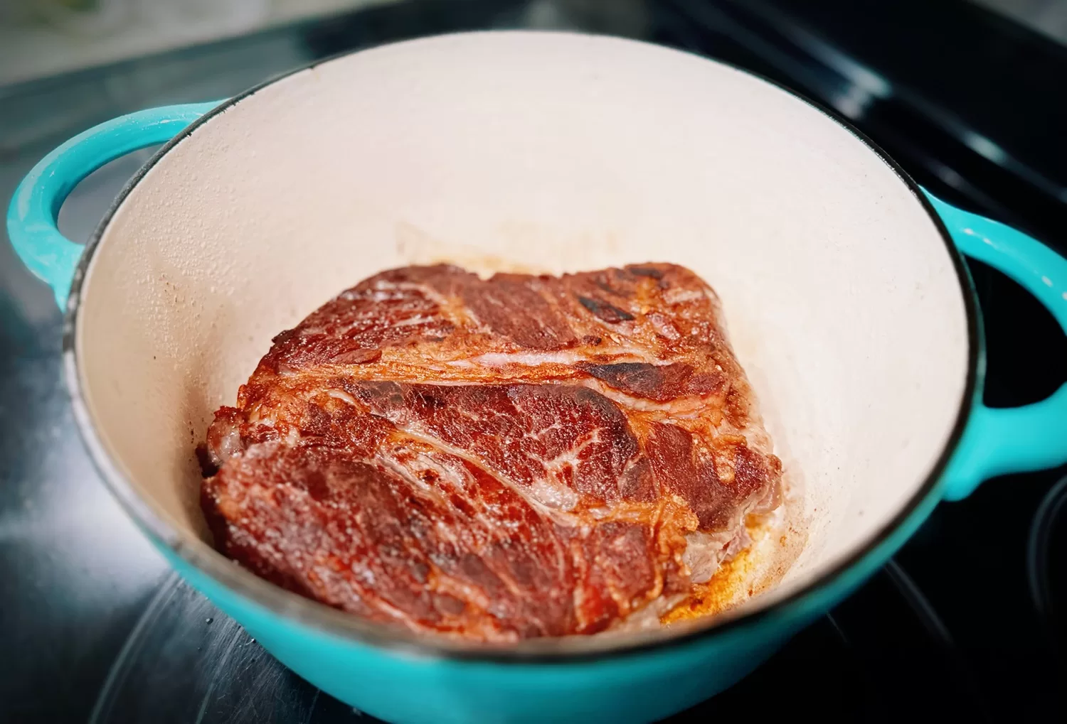 chuck roast searing in dutch oven