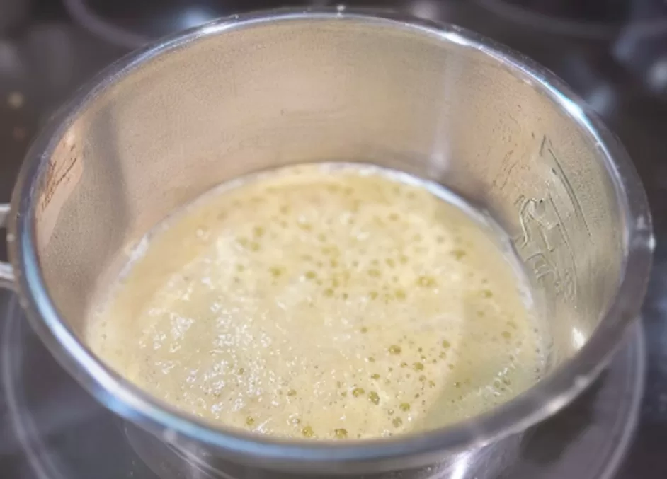 creamy Old Bay seasoned butter sauce bubbling in a sauce pan