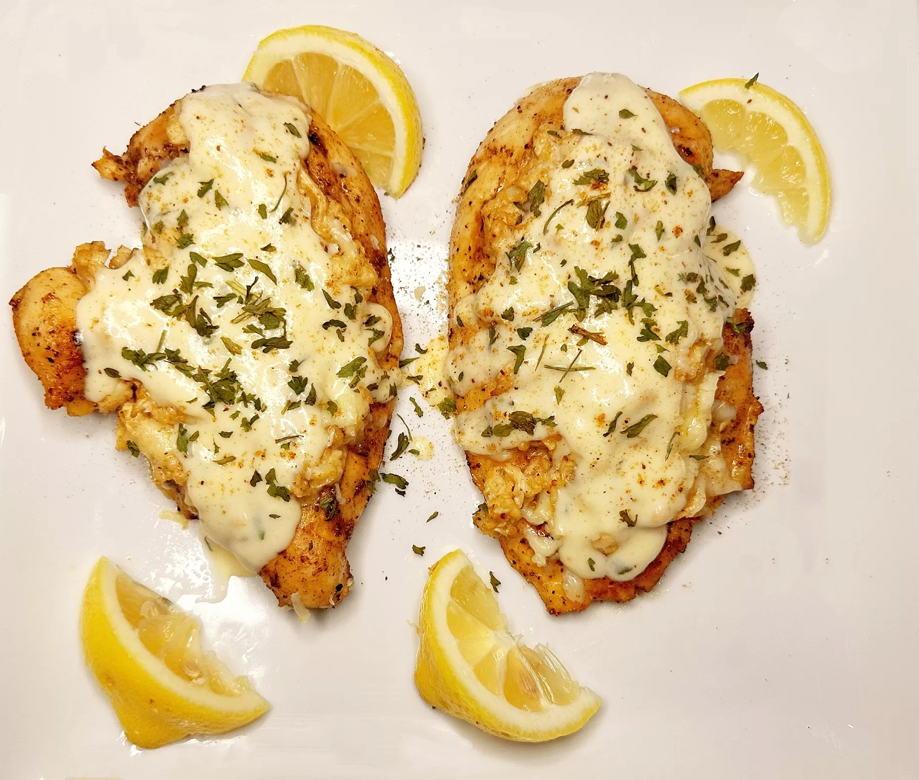 photo of Chicken Chesapeake garnished with lemons and parsley