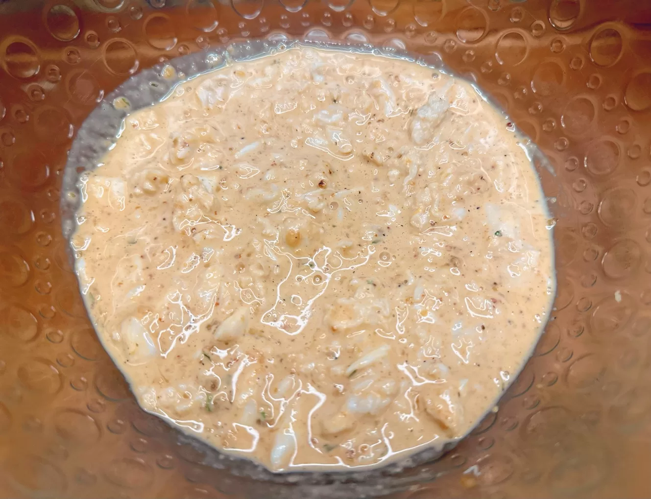 crab imperial mixture in a glass mixing bowl