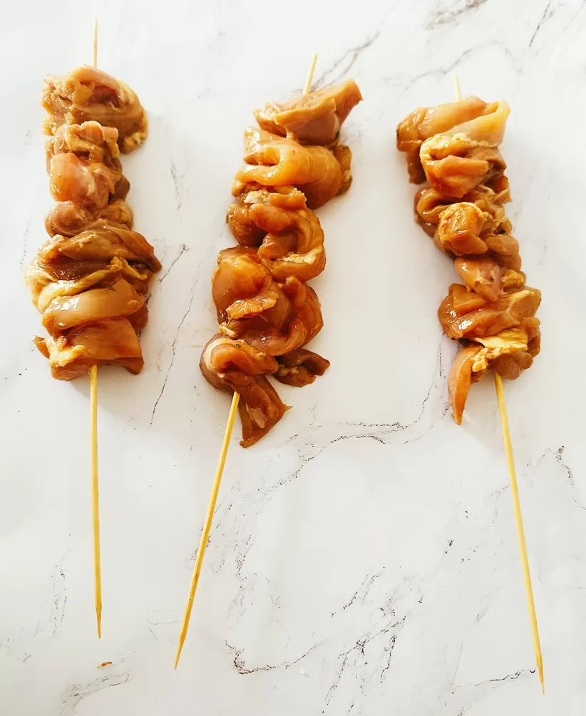 raw chicken on a skewer