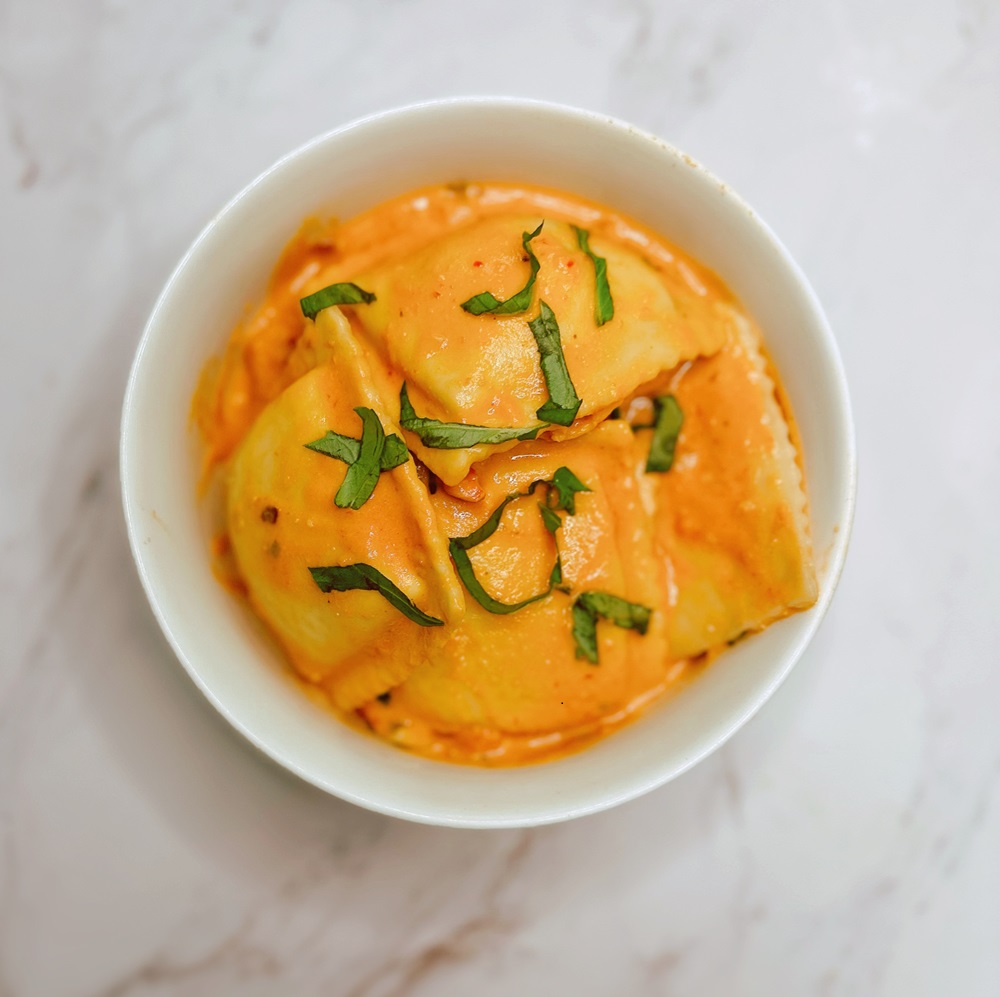 lobster ravioli in a bowl with fresh herbs