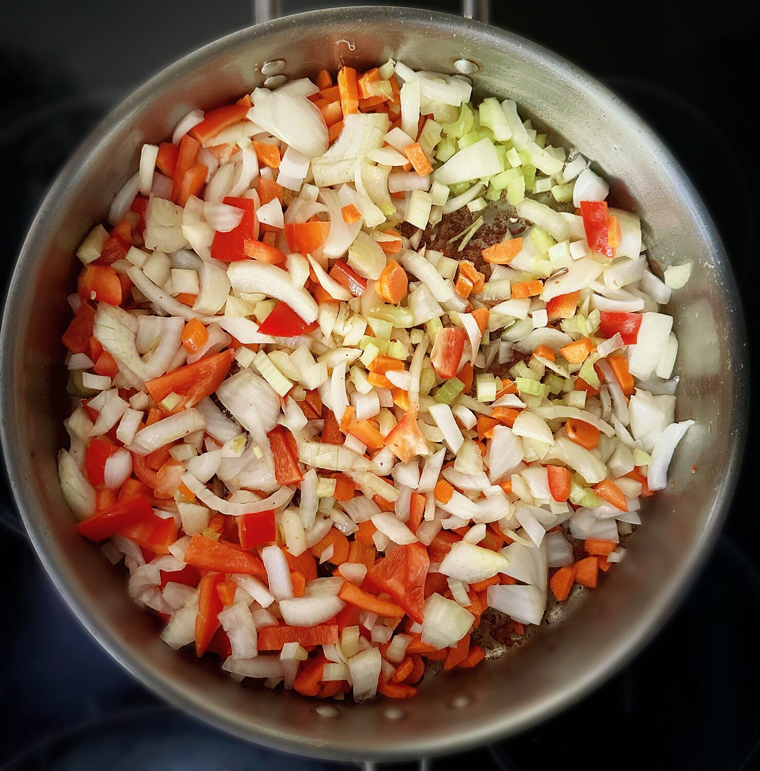 bell peppers and onions searing in a frying pan