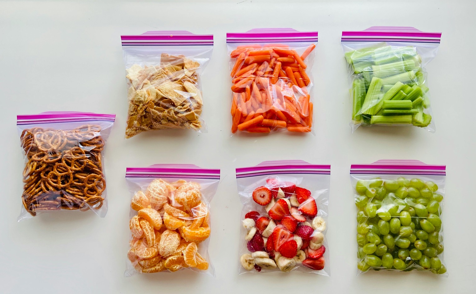 different snacks laid out in ziploc bags