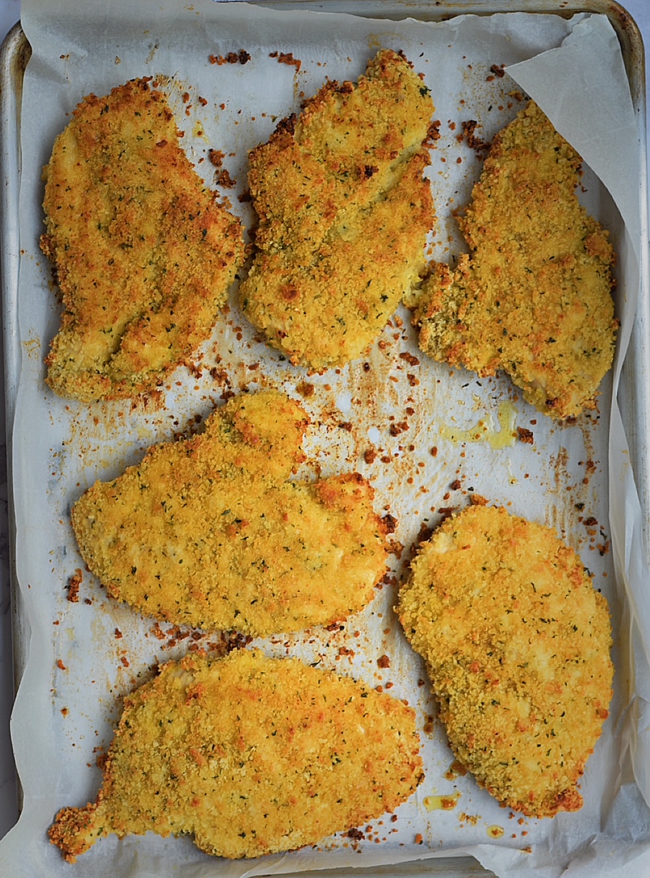 oven fried chicken on a baking sheet with parchment paper