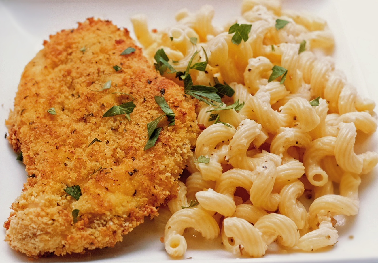 oven fried chicken with garlic parmesan sauce over cavatappi pasta