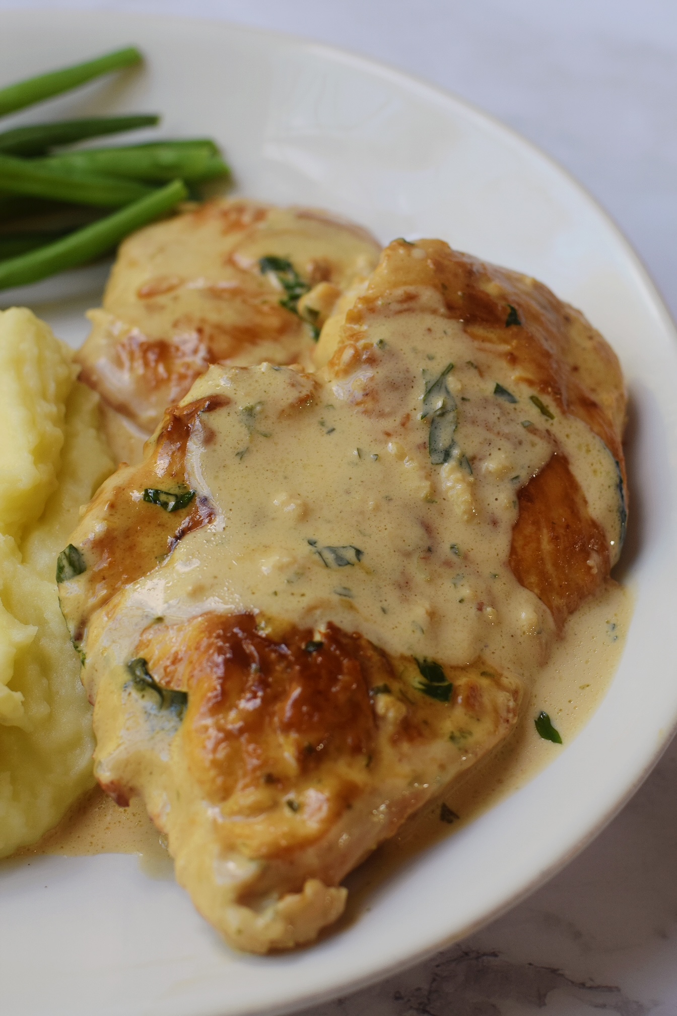 closeup photo of boursin chicken on a dinner plate