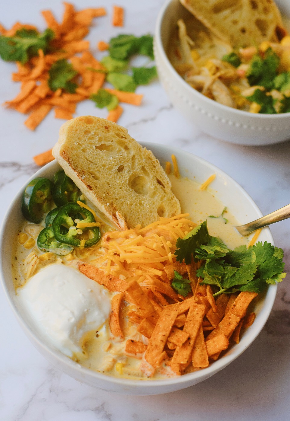 creamy white chicken chili with fresh bread dipped in chili