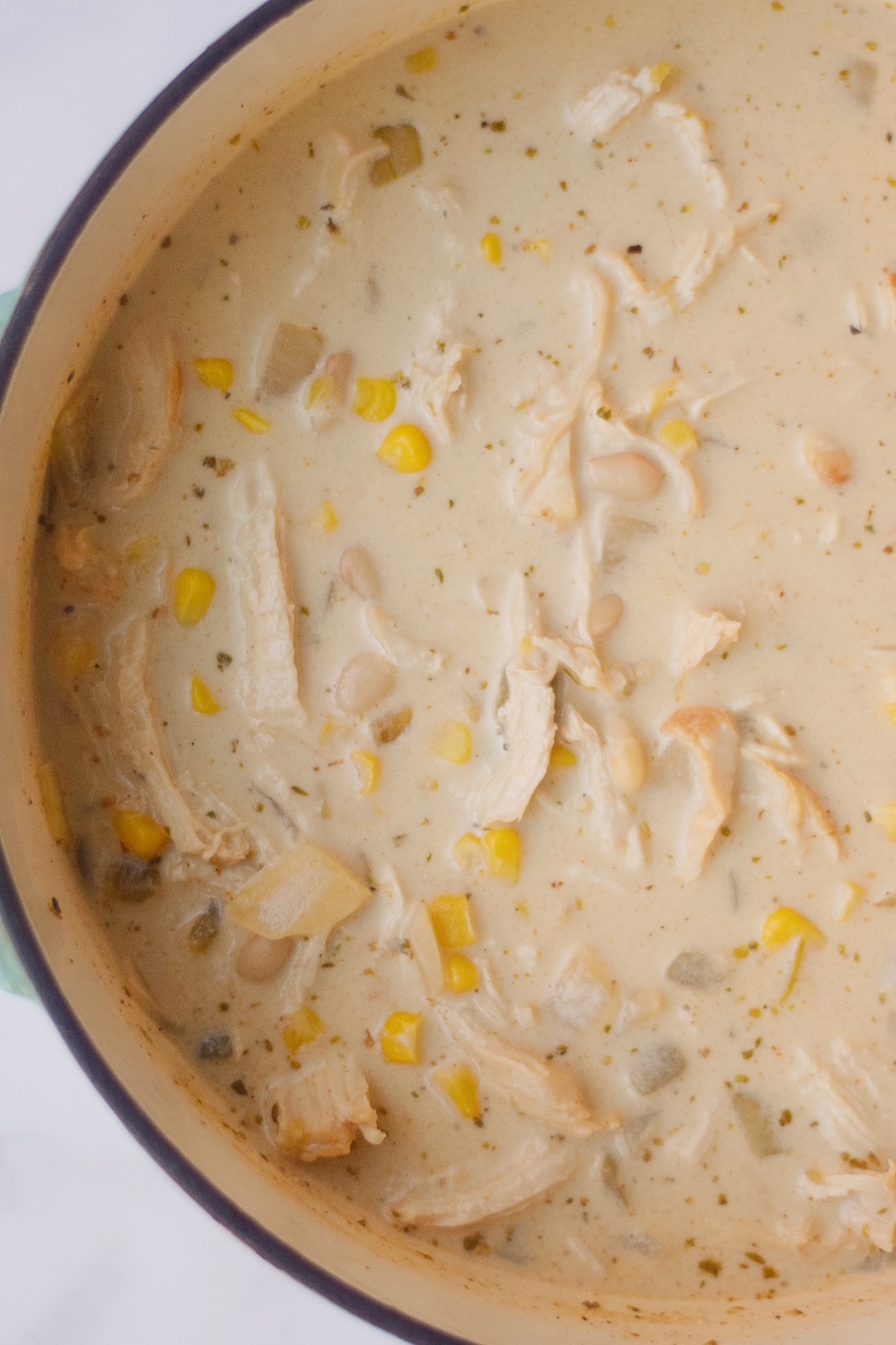 closeup of white chicken chili simmering in a pot