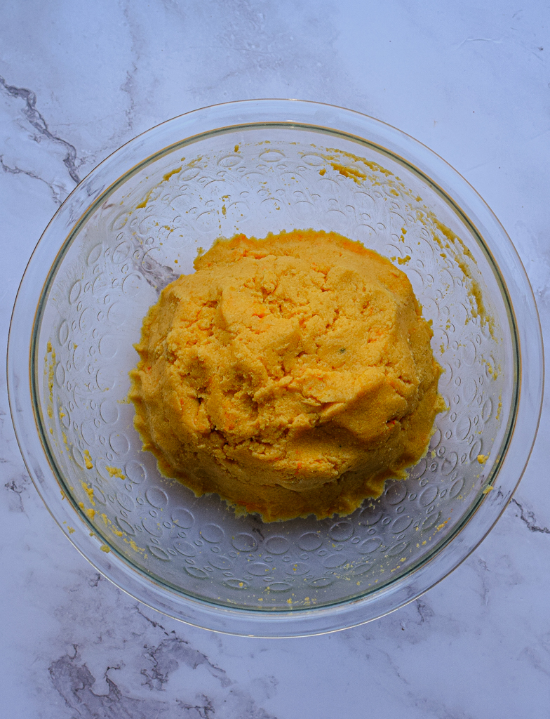 empanada dough rolled into a ball in a glass bowl