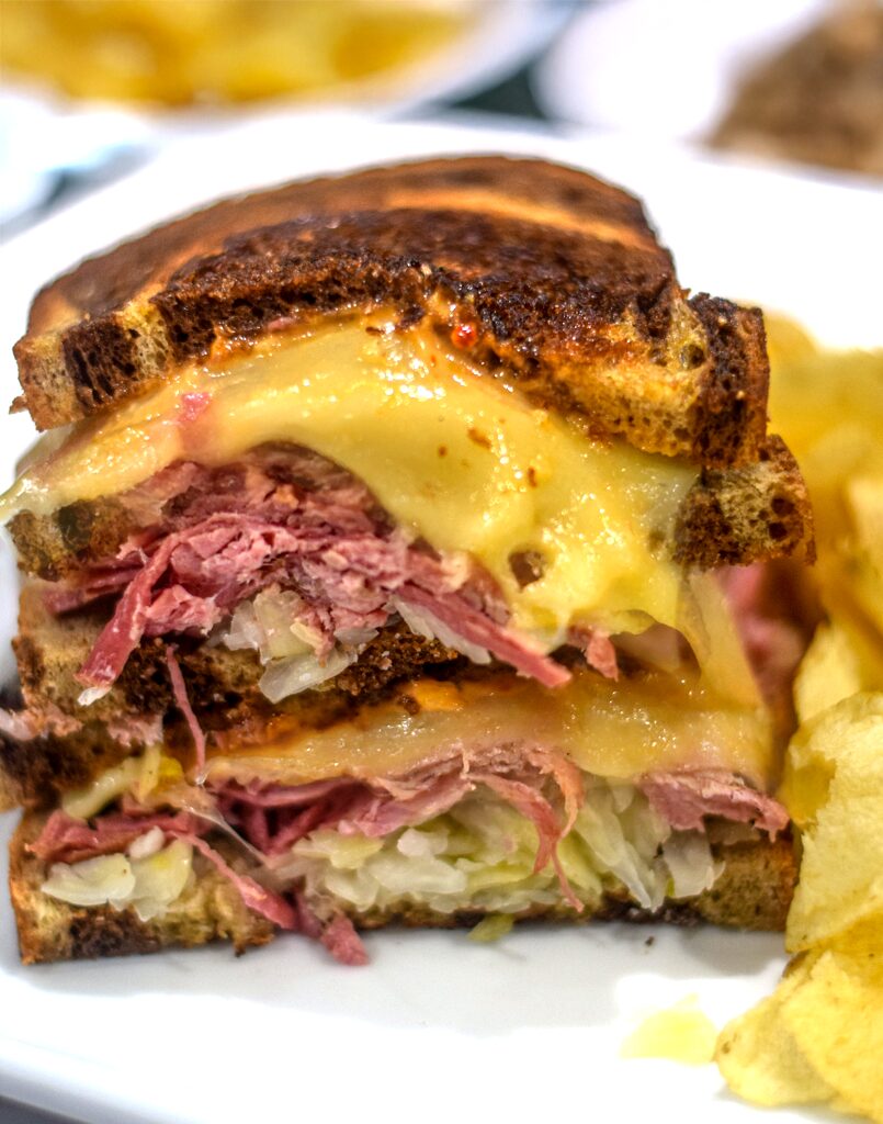 closeup of cheese melting on reuben sandwich