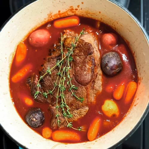 pot roast stew with vegetables in a dutch over