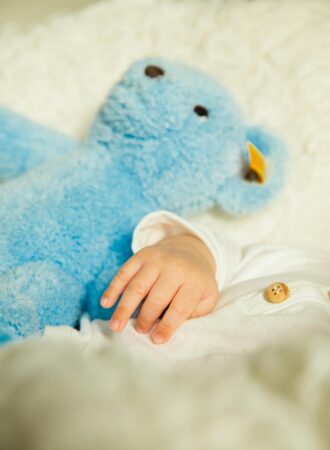 baby sleeping with teddy bear