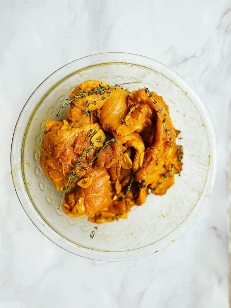 jamaican curry chicken marinating in a bowl