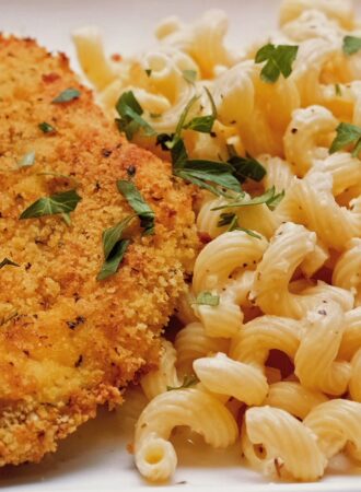 oven fried chicken with garlic parmesan sauce over cavatappi pasta