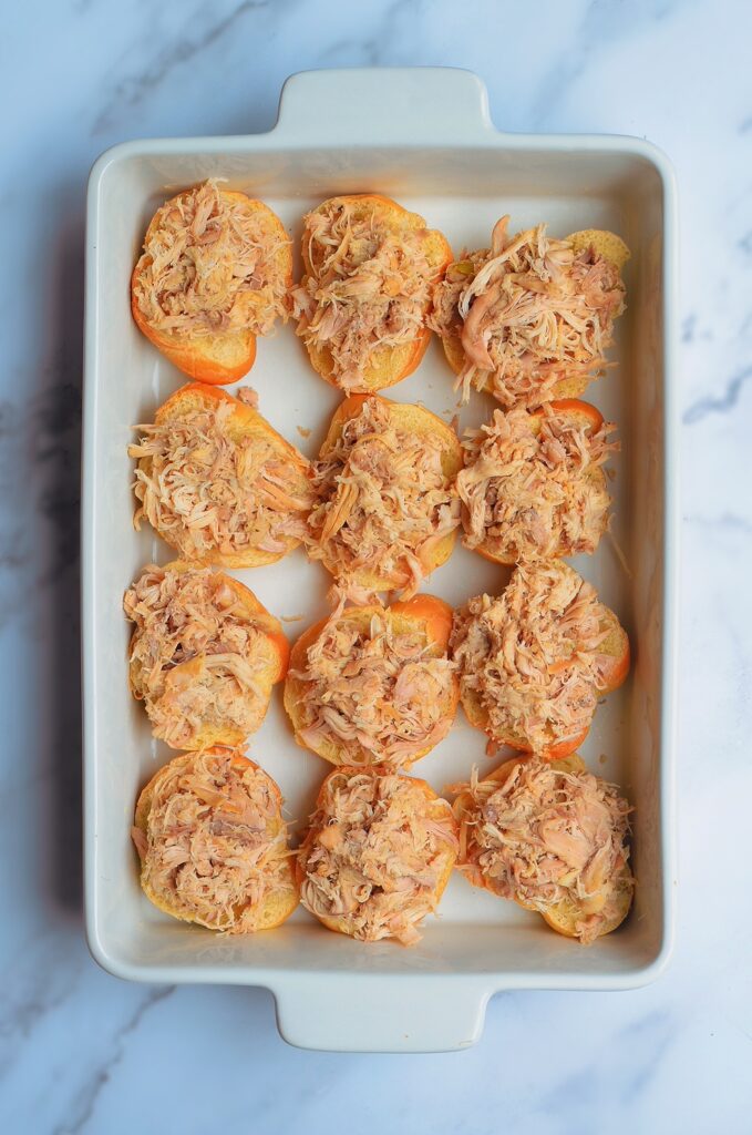 pulled chicken sliders in a white dish