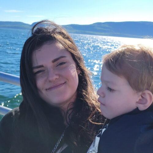 photo of briana holding her son on a boat