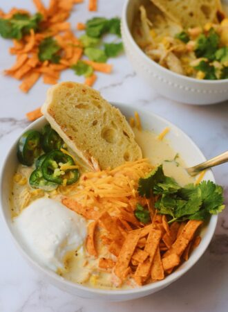 creamy white chicken chili with fresh bread dipped in chili