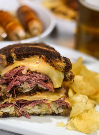 Reuben sandwich served on a plate with potato chips