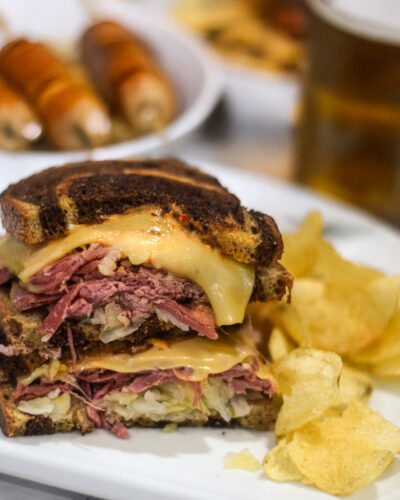 Reuben sandwich served on a plate with potato chips